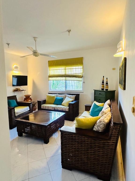 a living room with couches and a table at Villa del Sol #1 in La Laguna