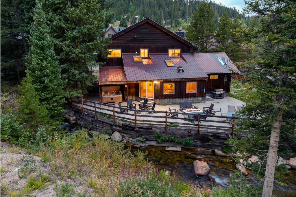 an overhead view of a log house with a porch at Slopeside Chalet on River Next To WP Resort I Fantastic Views I Private Hot Tub I Gas Firepit I Game Room I Activity Program in Winter Park