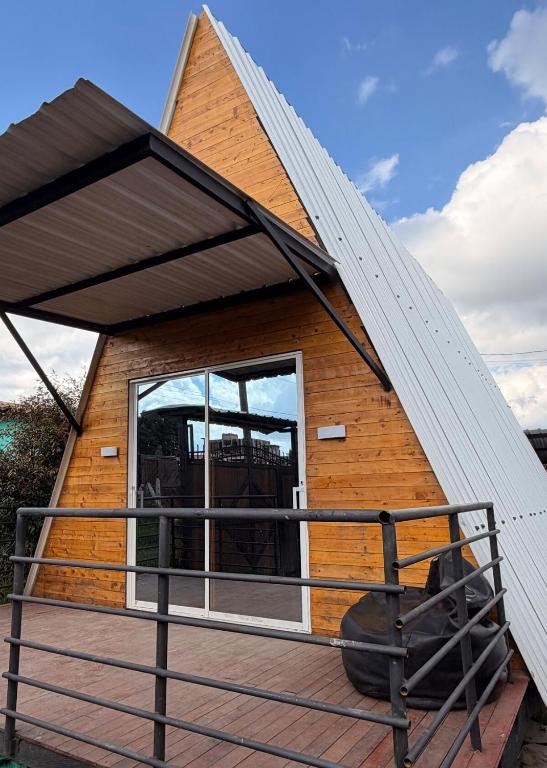 a tiny house with a pitched roof at Cabañas The Twins in Medellín