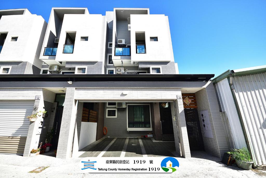 a white apartment building with a front entrance at Fengru B&B in Taitung City