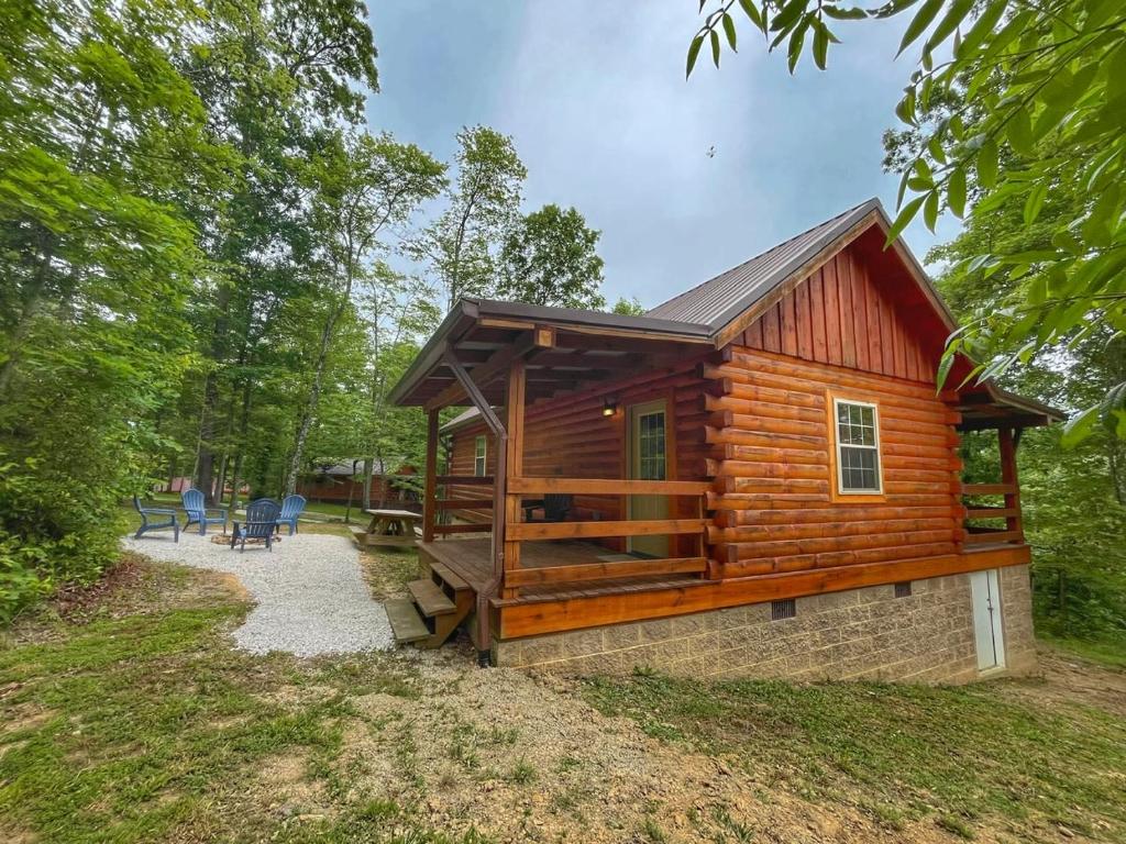 a log cabin in the woods with a patio at Pluggy's Place - Perfect Location - Outdoor Fire pit in Beattyville