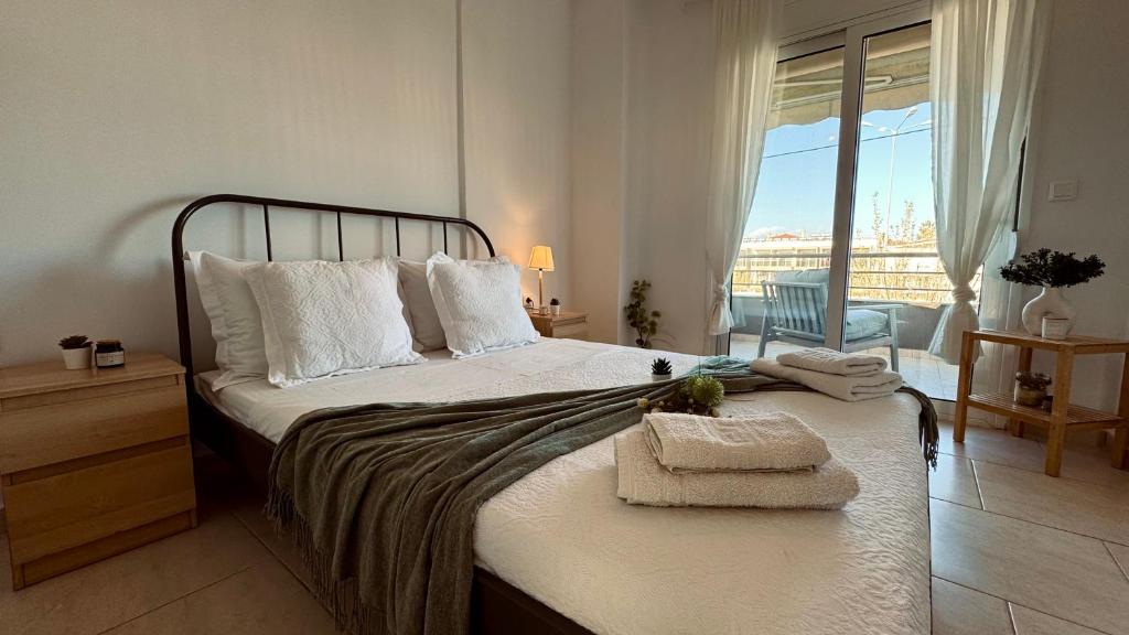 a bedroom with a bed with towels on it at 7th Heaven Luxury Villa in Kallithea Halkidikis