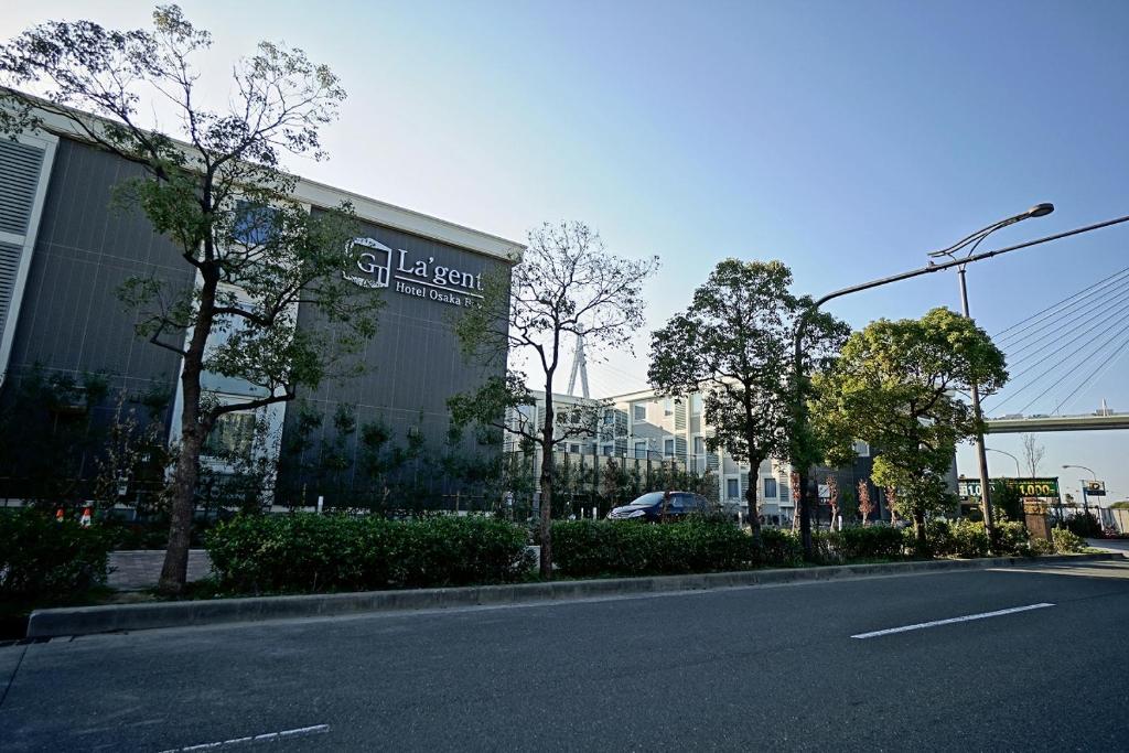 a building with a sign on the side of a street at La'gent Hotel Osaka Bay in Osaka