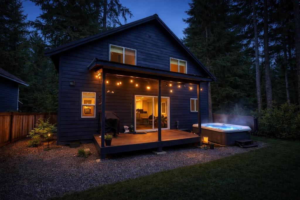 a tiny house with a deck and a hot tub at Perch - Serenity Nest in Ashford