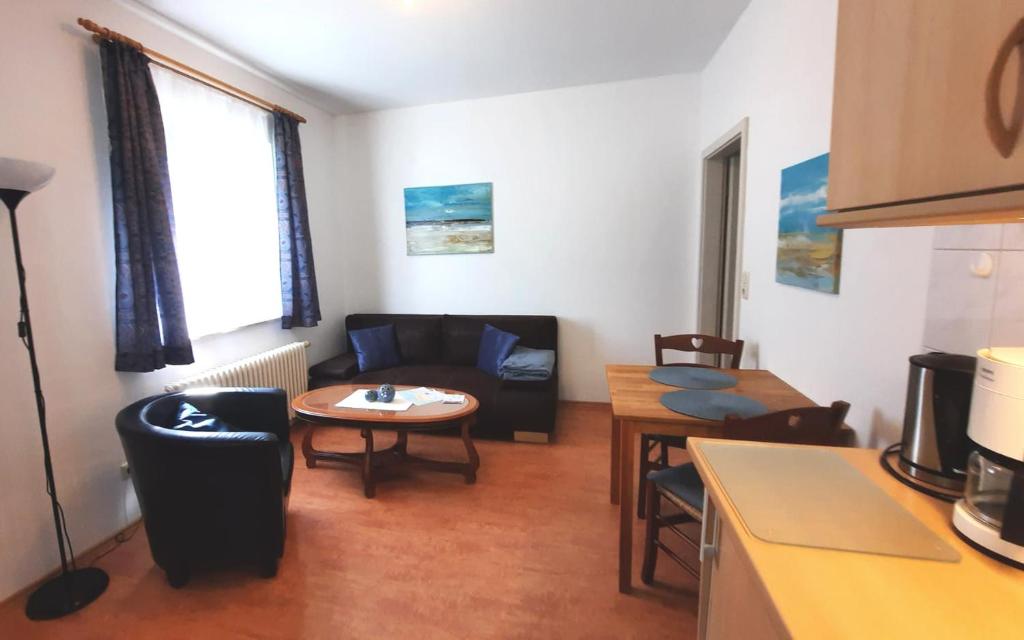 a living room with a couch and a table at Deichblick 02 in Prerow