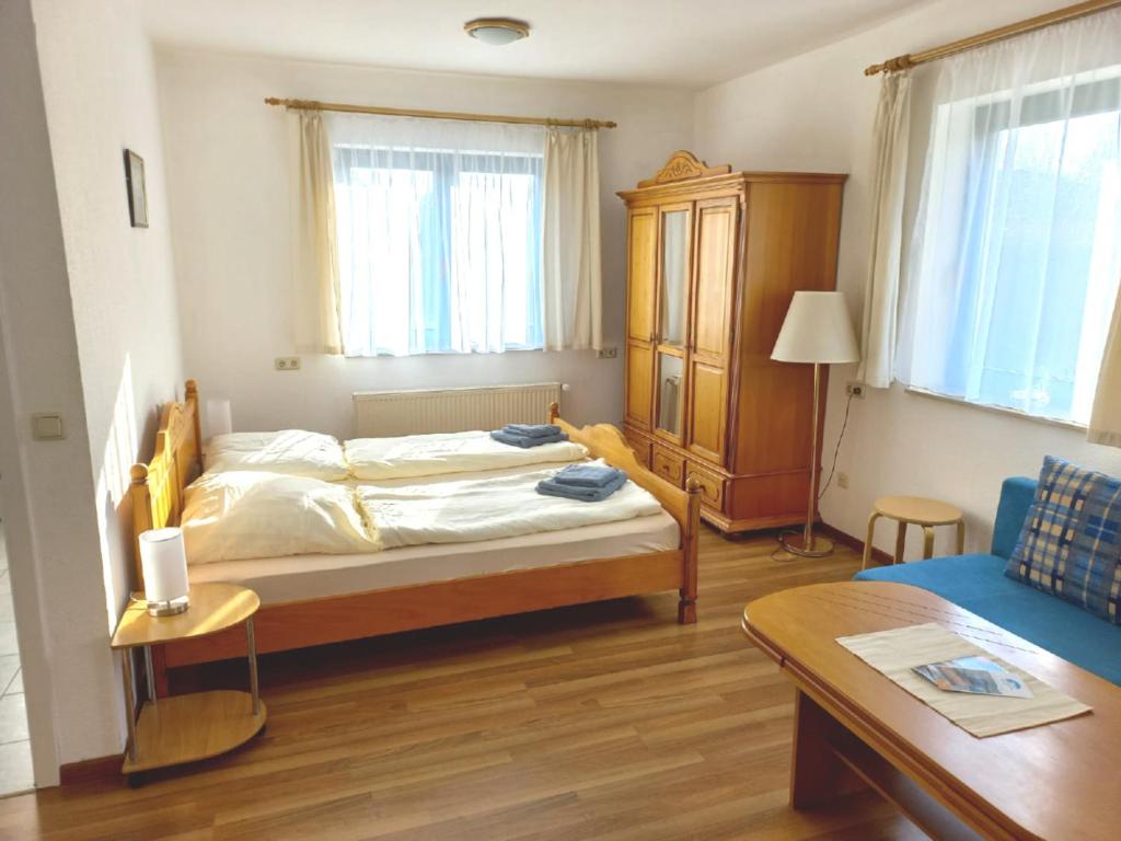 a bedroom with a bed and a table and a couch at Ostseedeich 08 in Prerow