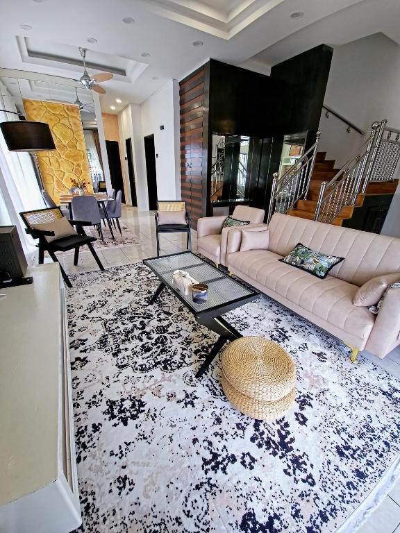 a living room with a couch and a table at #MyPawsomeGetaway, Fun Family Retreat, Tanah Rata, Cameron Highlands in Tanah Rata