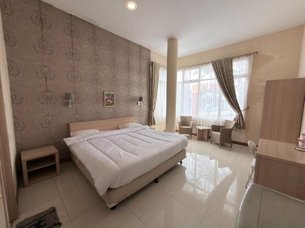 a bedroom with a large bed in a room at Guesthouse Anggrek BSD Syariah in Jombang-kulon