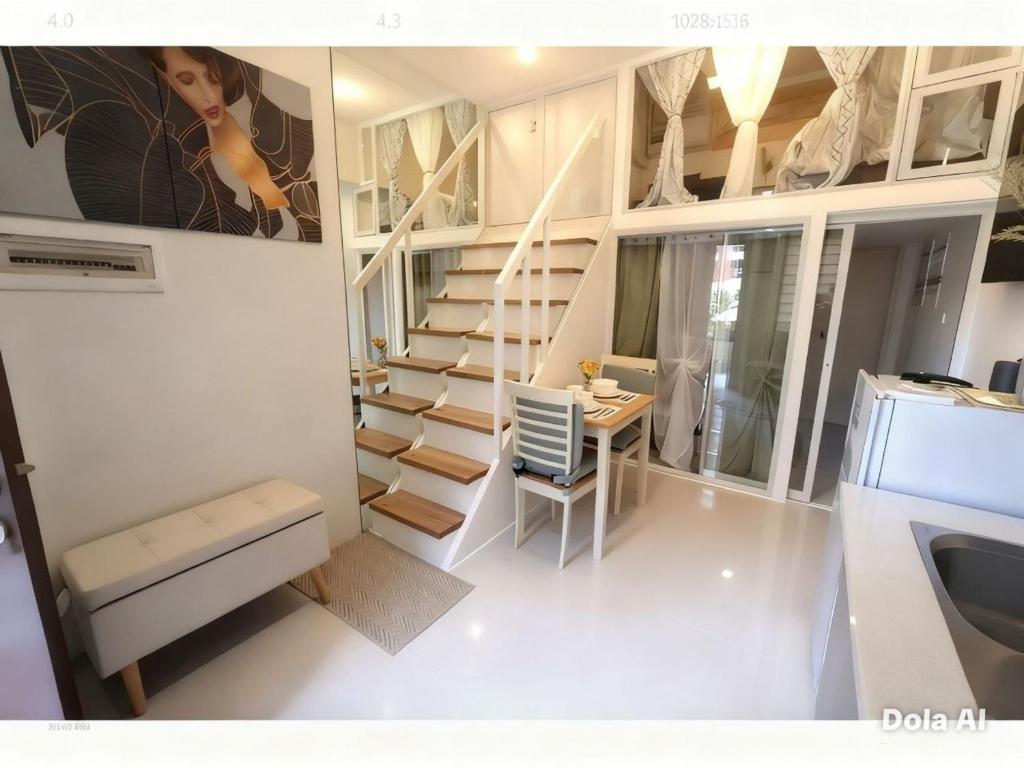 a small room with a staircase and a table at Prime World District Condo in Pajak