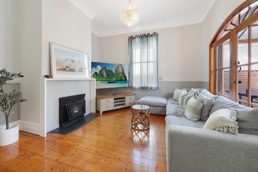 a living room with a couch and a fireplace at Morrissey Cottage in Warrnambool