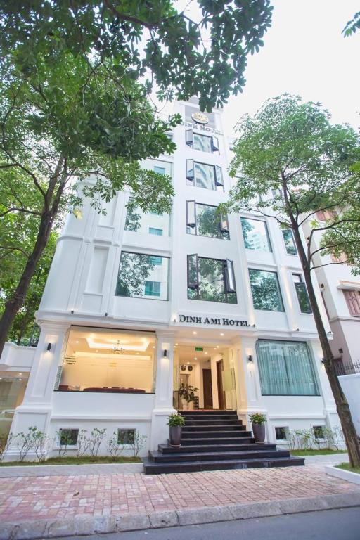a white building with stairs in front of it at Dinh Ami Hanoi Hotel in Hanoi