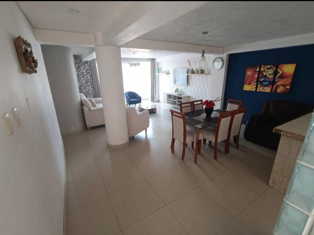 a living room and dining room with a table and chairs at Apart colección cusco in Cusco