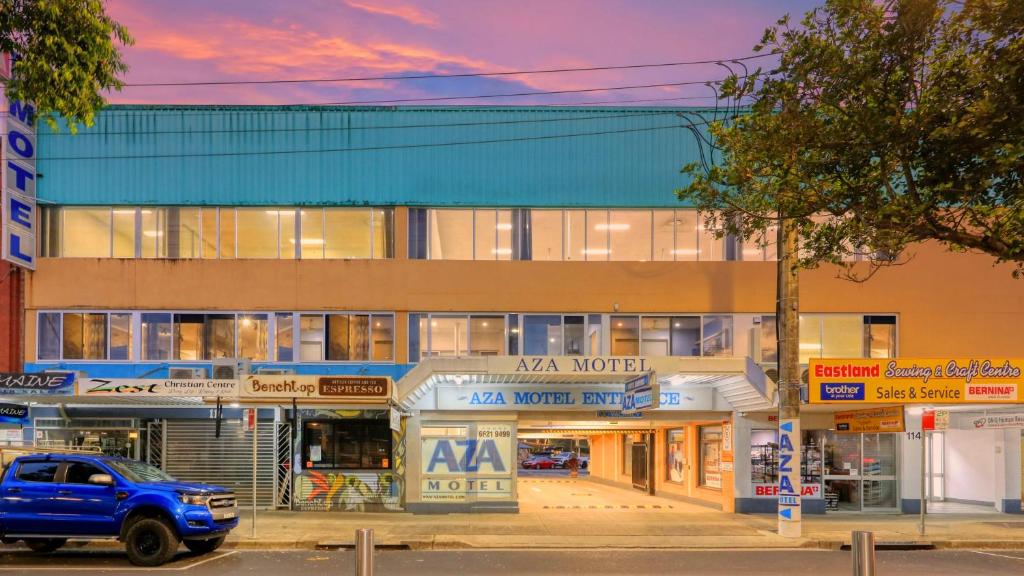 a building with a car parked in front of it at AZA Motel in Lismore