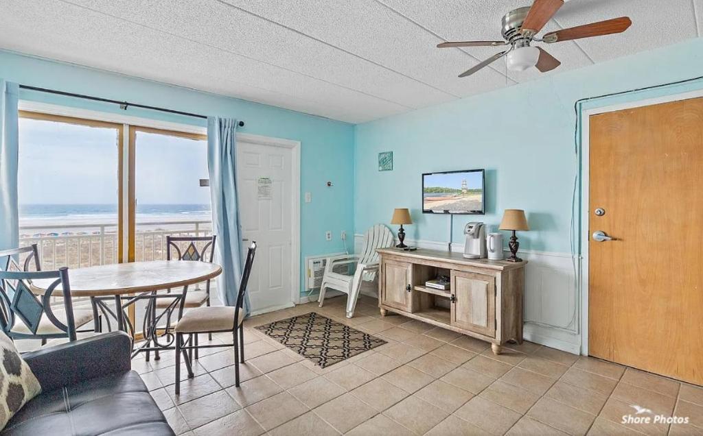 a living room with a table and chairs and a dining room at 1 Bedroom Beach Condo with a Pool & Balcony in Wildwood Crest