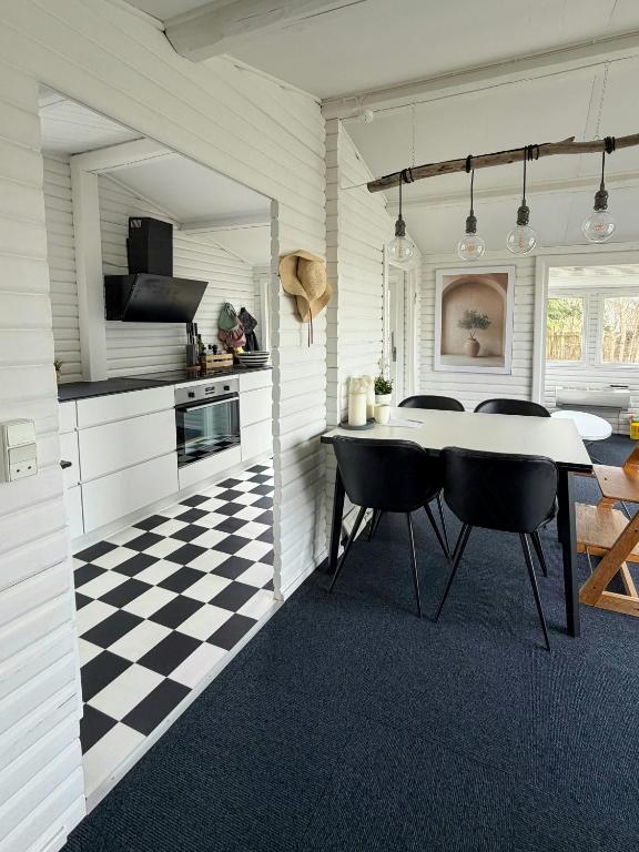 a kitchen with a black and white checkered floor at Holiday Home With A Direct Path To The Sea in Korsør