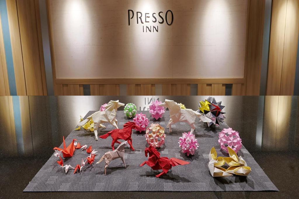 a display of figurines of horses on a table at Keio Presso Inn Gotanda in Tokyo
