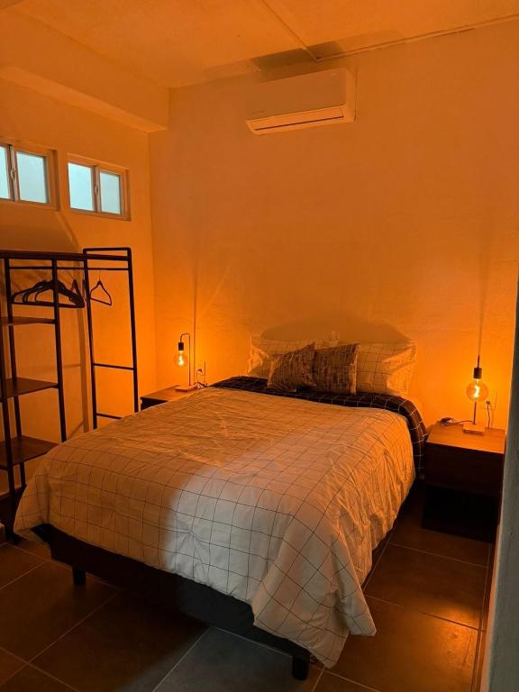 a bedroom with a bed in a room with orange walls at Freya studio IV Romantic Zone in Puerto Vallarta