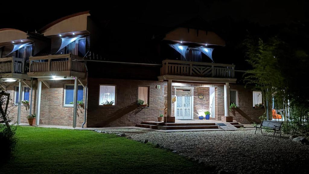 a house at night with the front door lit up at OwlCastle-Bagolyvár in Hajdúszoboszló