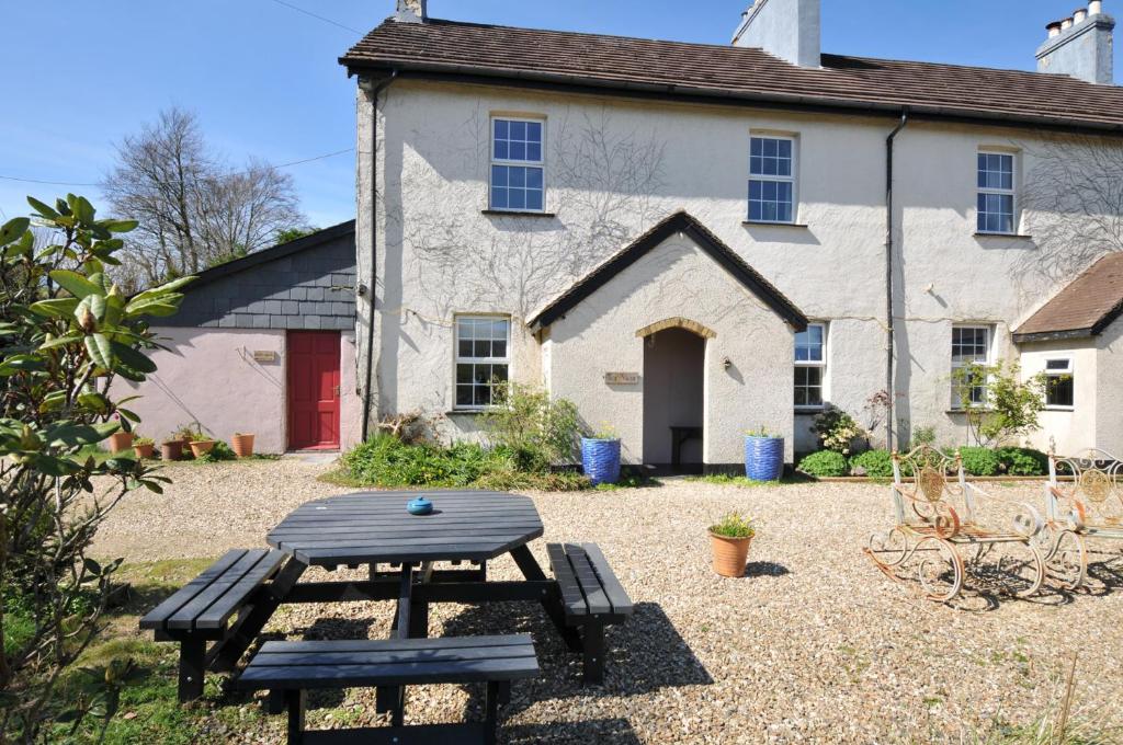 a picnic table in front of a building at Tor View Fourwinds in Okehampton