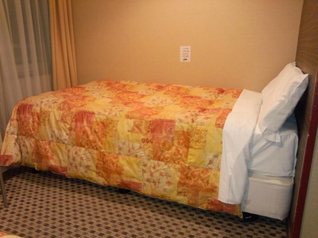 Postel nebo postele na pokoji v ubytování Hotel Matsumoto Hills