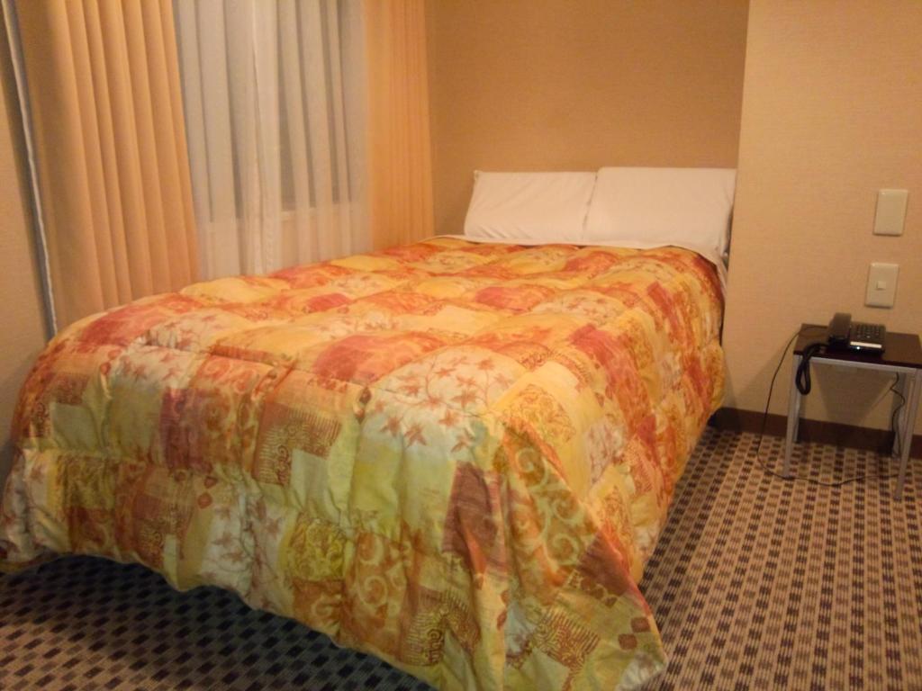 Postel nebo postele na pokoji v ubytování Hotel Matsumoto Hills