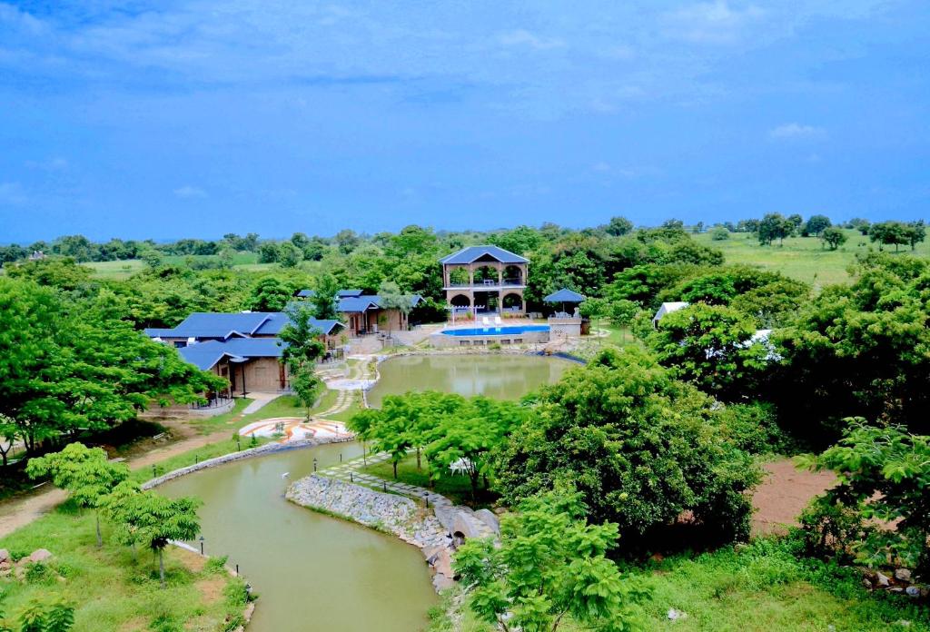 an aerial view of a resort with a pool and a river at Arbor Road Estate in Pāmalparti