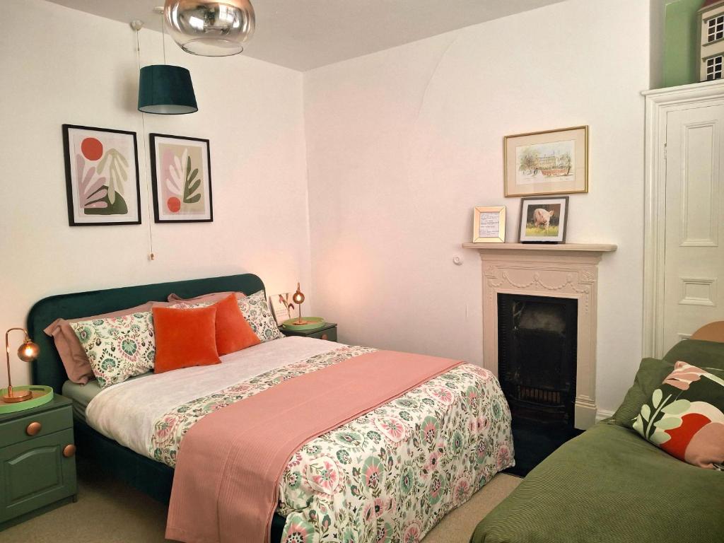a bedroom with a bed and a fireplace at JESMOND House B&B room 1 in Hull