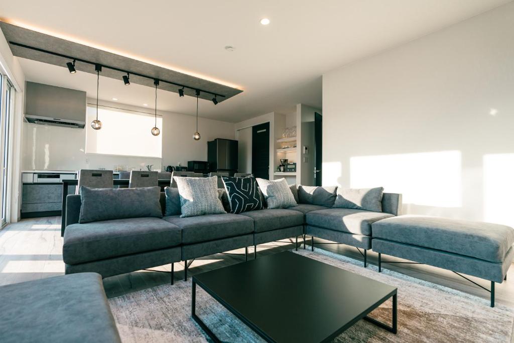 a living room with a couch and a table at Grandeur Biei in Biei