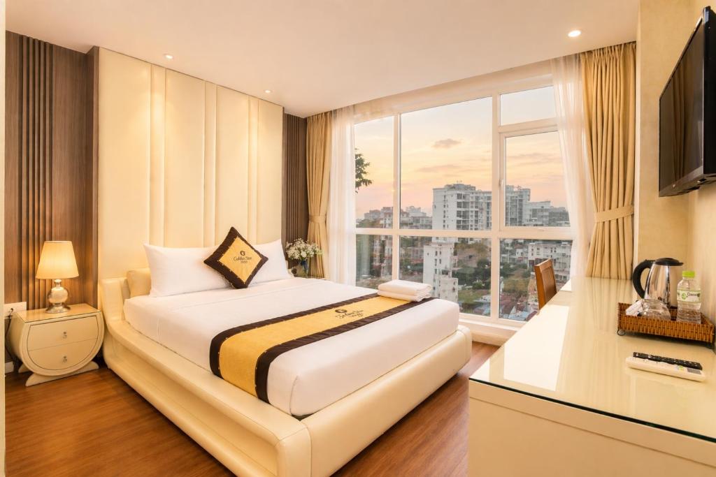a hotel room with a bed and a large window at Golden Star Hotel in Ho Chi Minh City