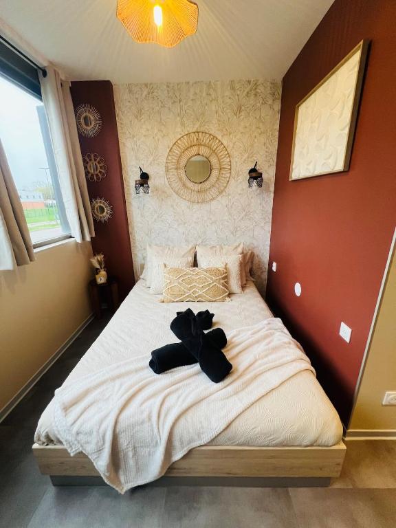 a bedroom with a bed with a bow on it at Le Stud in Vandoeuvre-lès-Nancy