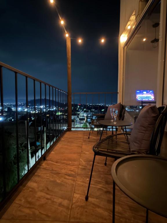 a balcony with a view of a city at night at PH 41 Metepec in Toluca