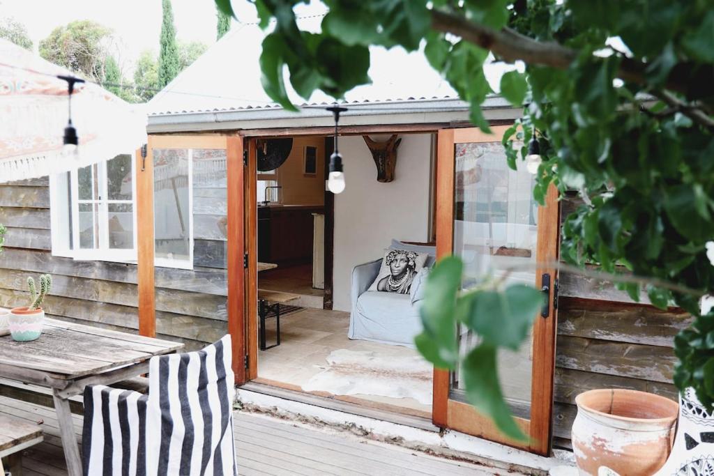 a wooden shed with a table and a bench at Mr Banks in Robe