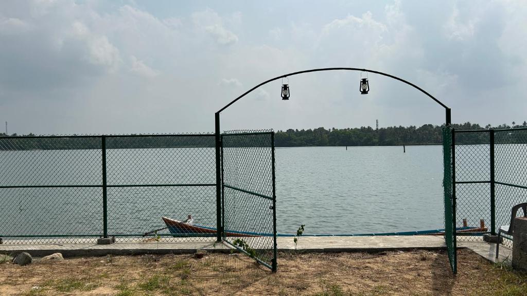 a batting cage next to a large body of water at Athulya Tropical Paradise in Paravūr