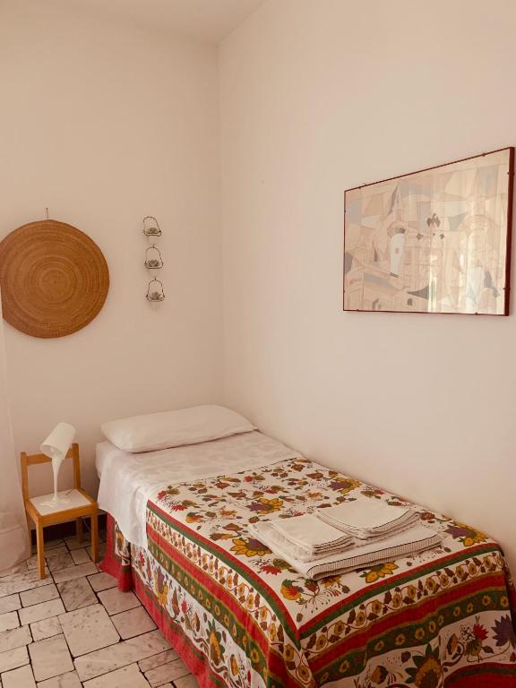 a bedroom with a bed and a picture on the wall at Villa Fiorentino in Ivrea