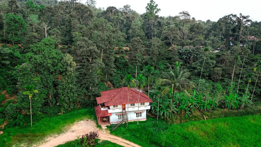 a small house in the middle of a field at Brookfield estate villa 2bhk in Madikeri