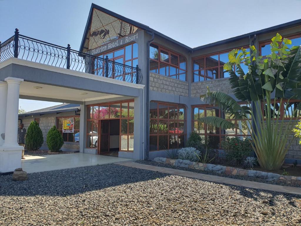 a large building with a balcony on top of it at OLOIRIEN HOTEL & RESORT in Narok