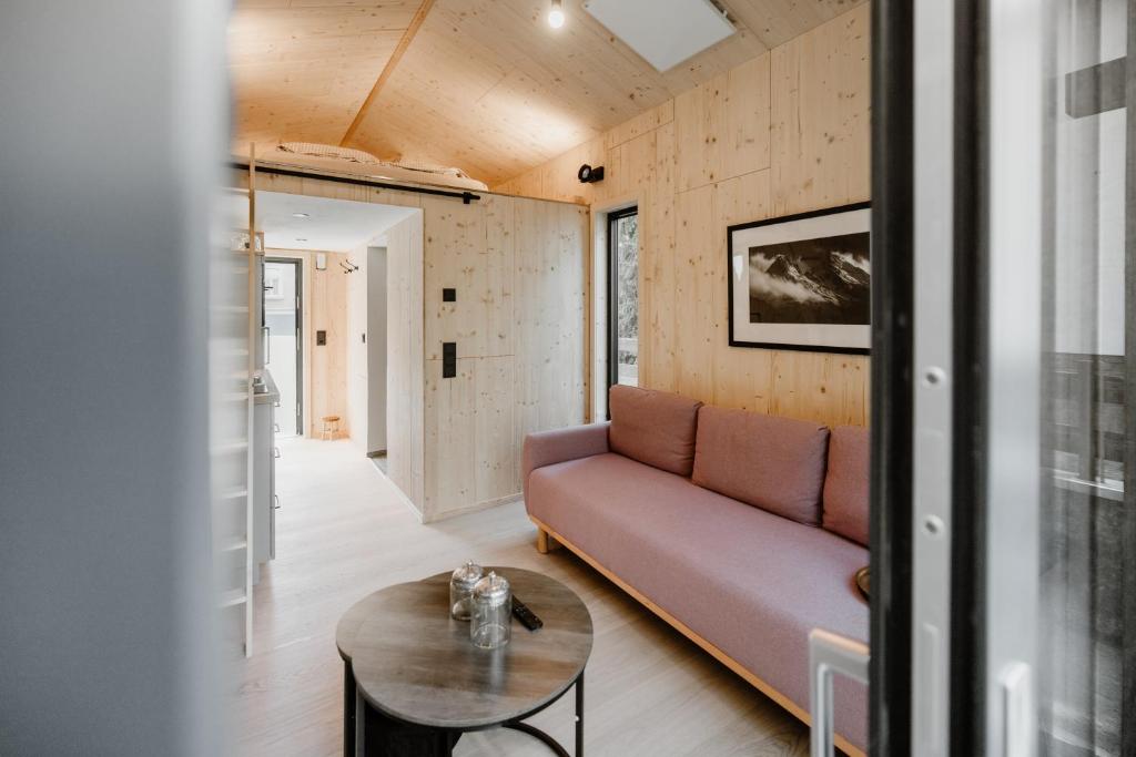 a living room with a couch and a table at Tiny Chalet in Blankenburg