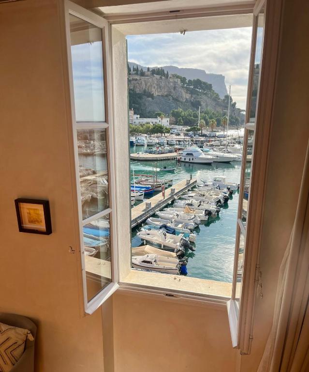 a window view of a marina with boats in the water at Le Régali par Dodo-a-Cassis in Cassis