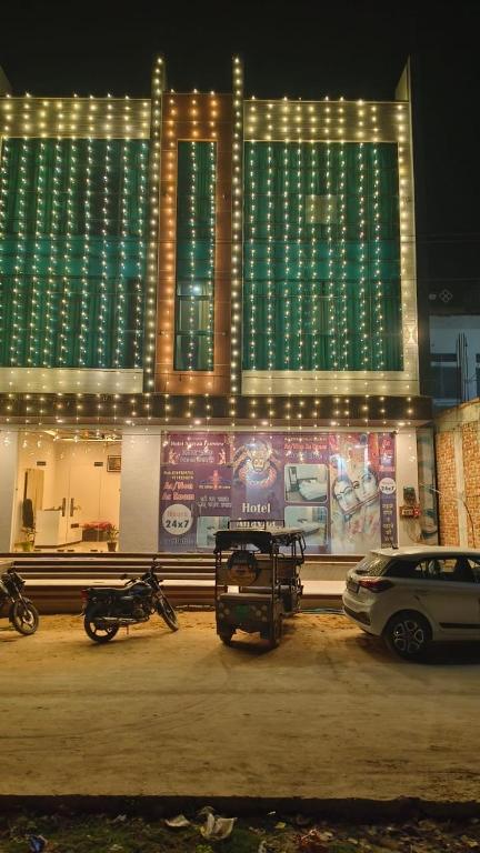 a building with motorcycles parked in a parking lot at night at Fairview Anayaa in Khātu
