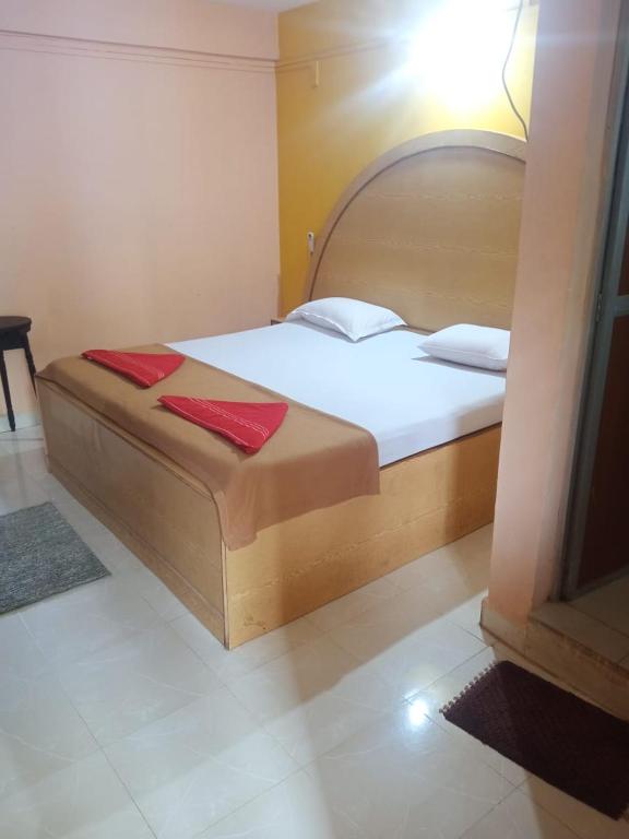 a bedroom with a bed with red towels on it at Dmello guesthouse in Palolem