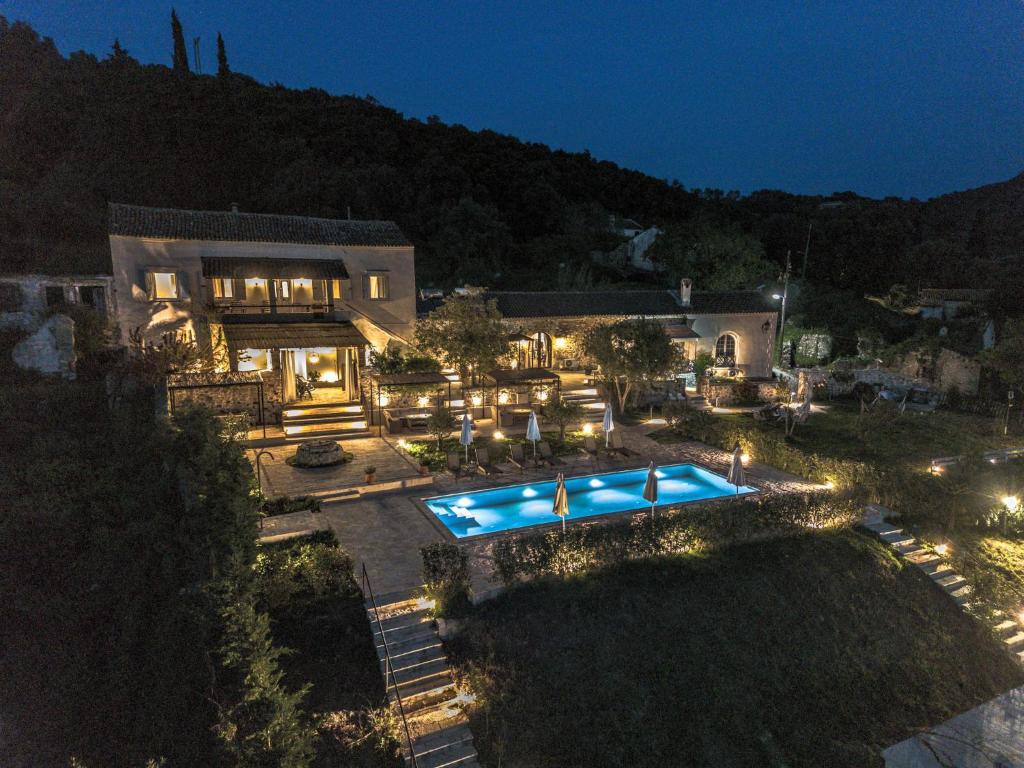 an aerial view of a house with a swimming pool at night at Marcora Historic Mansion in Strongylí