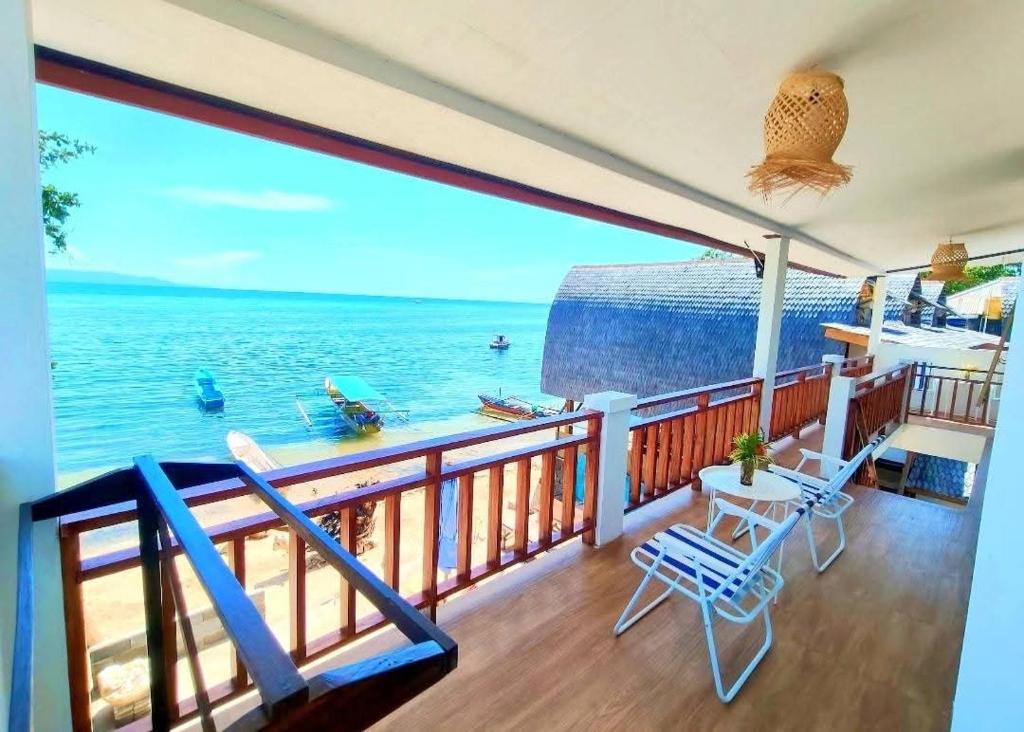 a balcony with a view of the ocean at Bunaken Paradise Beach Homestay in Bunaken