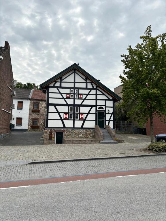 a black and white building on the side of a street at D'r Preëksjtool in Eygelshoven
