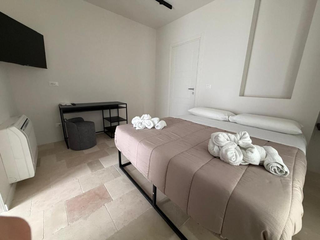 a bedroom with a bed with towels on it at Affittacamere gold 5 in Barletta