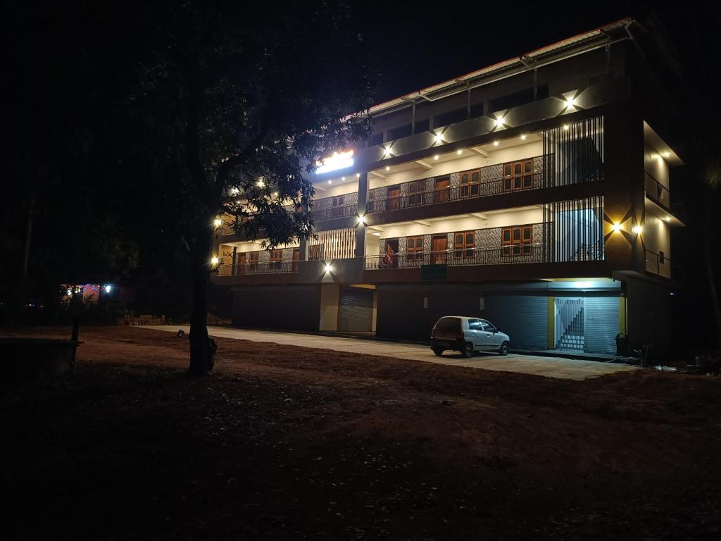 a car parked in front of a building at night at Gokula Arcade in Subrahmanya