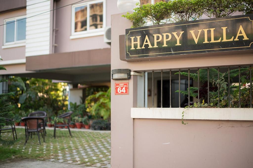 a happy villa sign on the side of a building at Happy Villa Guest House in Guwahati