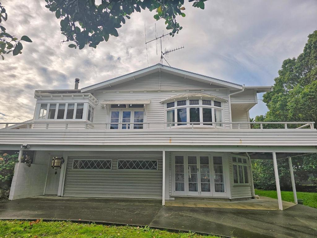 a large white house with a large garage at 21 Villa in Whangarei