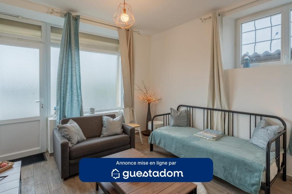 a bedroom with a bed and a chair and window at Le Sostranien - Jardin - Wifi in La Souterraine
