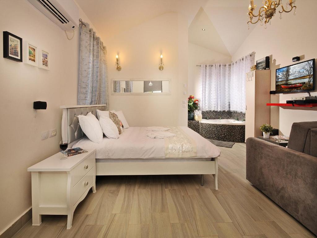 a bedroom with a bed and a living room at Gal Golan Suites in Had Nes