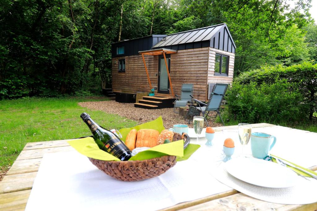 a picnic table with a basket of bread and a cabin at Kleines Ems-Idyll in Lathen